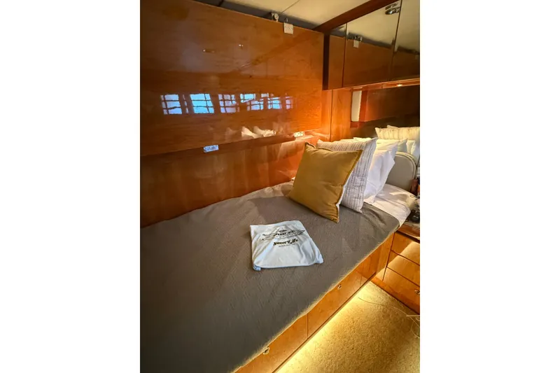 Slide: The Image of Luxurious cabin interior of 2001 Hargrave 94 yacht with cozy bedding and warm lighting. - 84