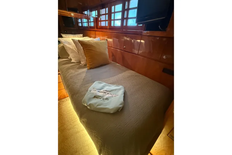 Slide: The Image of Luxurious cabin interior of 2001 Hargrave 94 yacht with cozy bedding and ambient lighting. - 85
