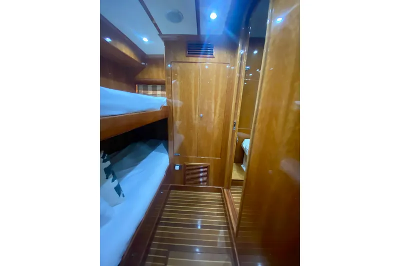 Slide: The Image of Luxurious wooden interior of a 2001 Hargrave 94 yacht cabin with bunk beds. - 86