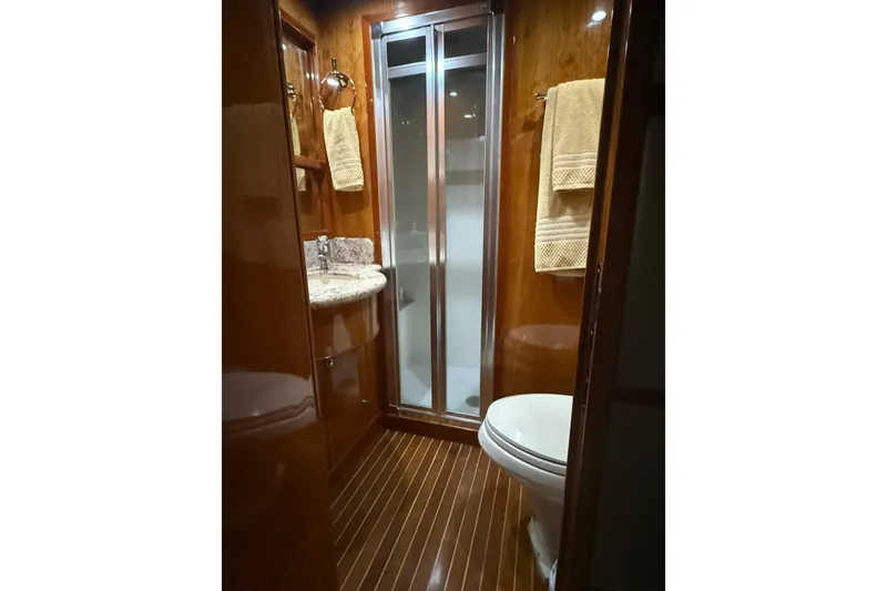 Slide: The Image of Luxurious bathroom in 2001 Hargrave 94 yacht with wood paneling and modern fixtures. - 87