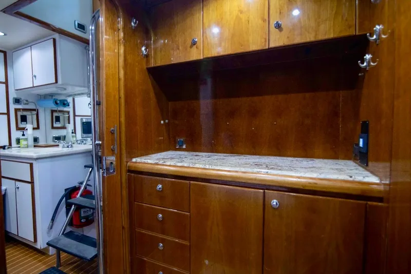 Slide: The Image of Luxurious wooden cabinetry in a 2001 Hargrave 94 yacht interior, featuring ample storage space. - 89