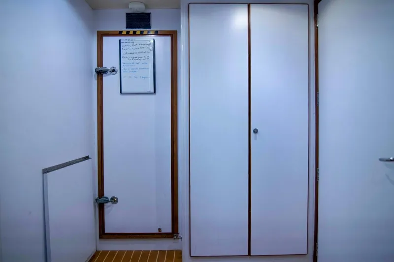 Slide: The Image of Interior of 2001 Hargrave 94 yacht with white door and wooden accents. - 95