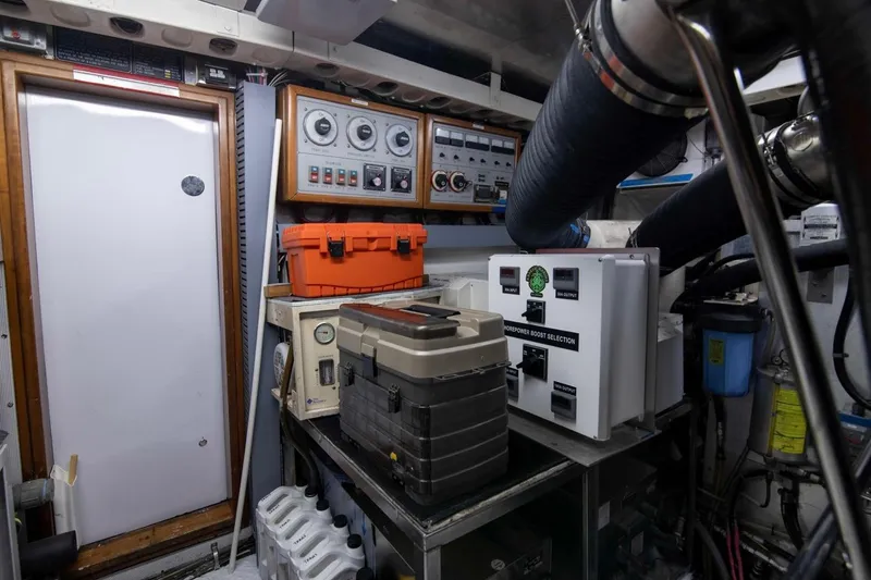 Slide: The Image of Engine room of a 2001 Hargrave 94 yacht with control panels and equipment. - 96