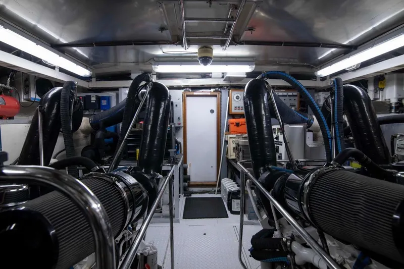 Slide: The Image of Engine room of a 2001 Hargrave 94 yacht, featuring complex machinery and equipment. - 97