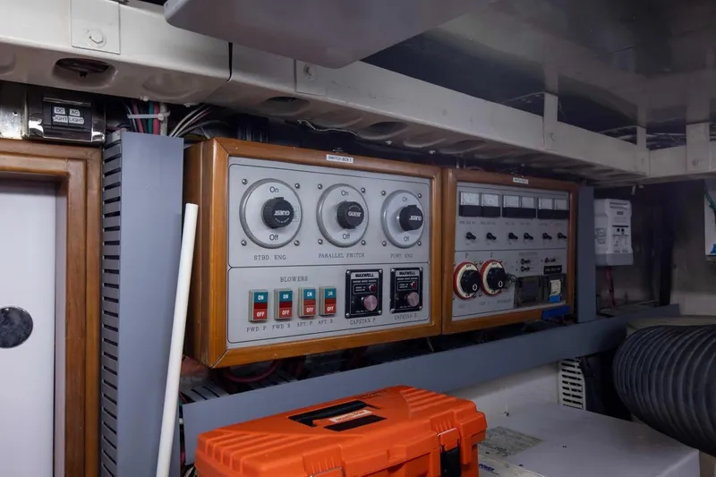 Slide: The Image of Control panel in a 2001 Hargrave 94 yacht engine room, featuring switches and gauges. - 98