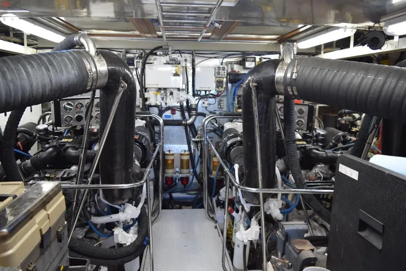 Slide: The Image of Engine room of a 2001 Hargrave 94 yacht, showcasing complex machinery and piping. - 99