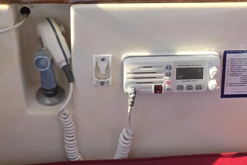 Slide: The Image of VHF radio and microphone on 1989 Island Packet 35 sailboat dashboard. - 20
