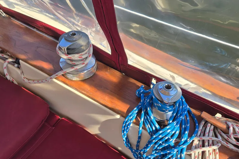Slide: The Image of Winches and ropes on 1989 Island Packet 35 sailboat deck, featuring red and blue lines. - 21