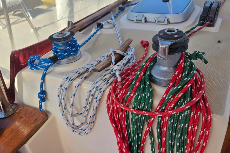 Slide: The Image of Colorful ropes and winches on a 1989 Island Packet 35 sailboat deck. - 23