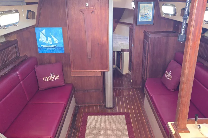 Slide: The Image of Interior of 1989 Island Packet 35 sailboat with red seating and nautical decor. - 27
