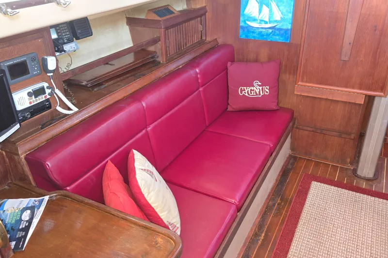 Slide: The Image of Interior of 1989 Island Packet 35 sailboat with red seating and nautical decor. - 28
