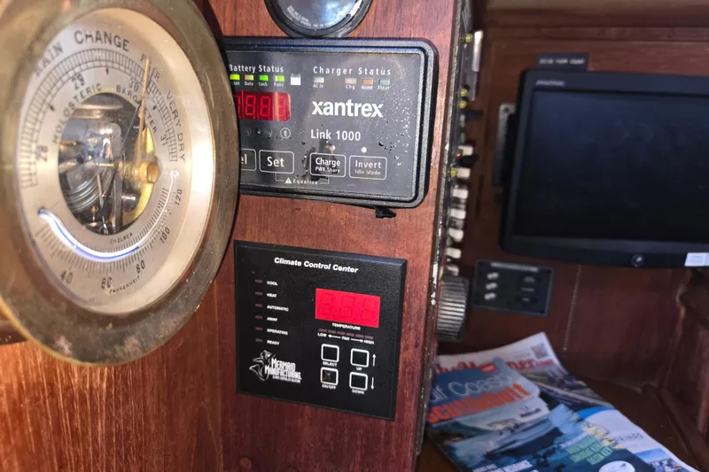 Slide: The Image of Interior of 1989 Island Packet 35 sailboat with barometer, climate control, and battery status display. - 35