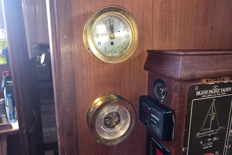 Slide: The Image of Interior of 1989 Island Packet 35 yacht with clock and barometer on wooden panel. - 37
