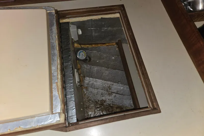 Slide: The Image of Open compartment in 1989 Island Packet 35 sailboat, showing interior details and gauge. - 41