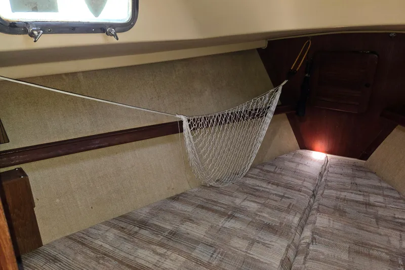 Slide: The Image of Interior cabin of a 1989 Island Packet 35 sailboat with a hammock and cushioned berth. - 47