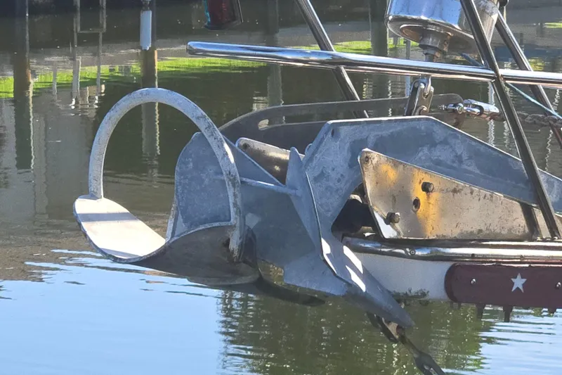 Slide: The Image of Anchor of 1989 Island Packet 35 sailboat reflecting on calm water. - 57