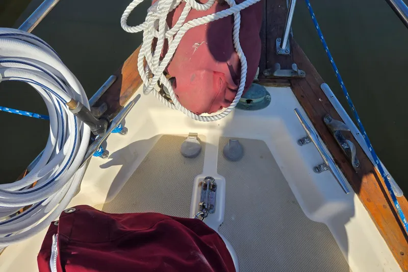 Slide: The Image of Bow of 1989 Island Packet 35 sailboat with ropes and deck fittings. - 59