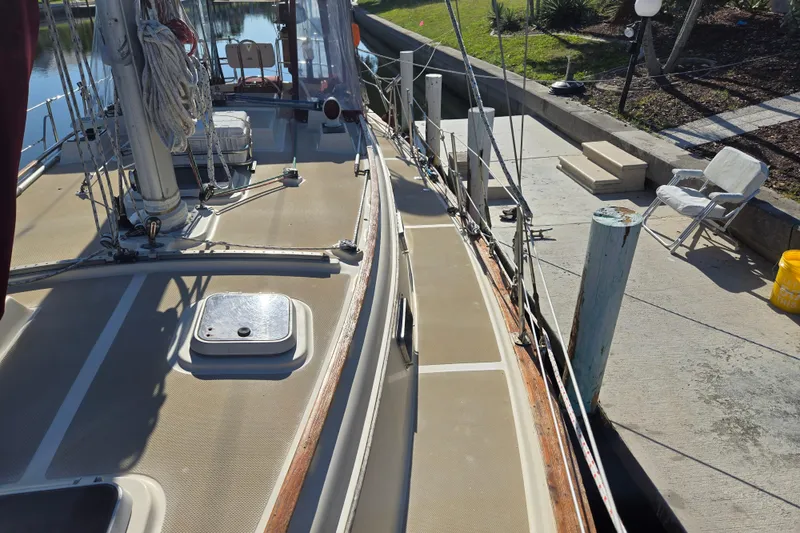 Slide: The Image of 1989 Island Packet 35 sailboat docked, showing deck and rigging details. - 60