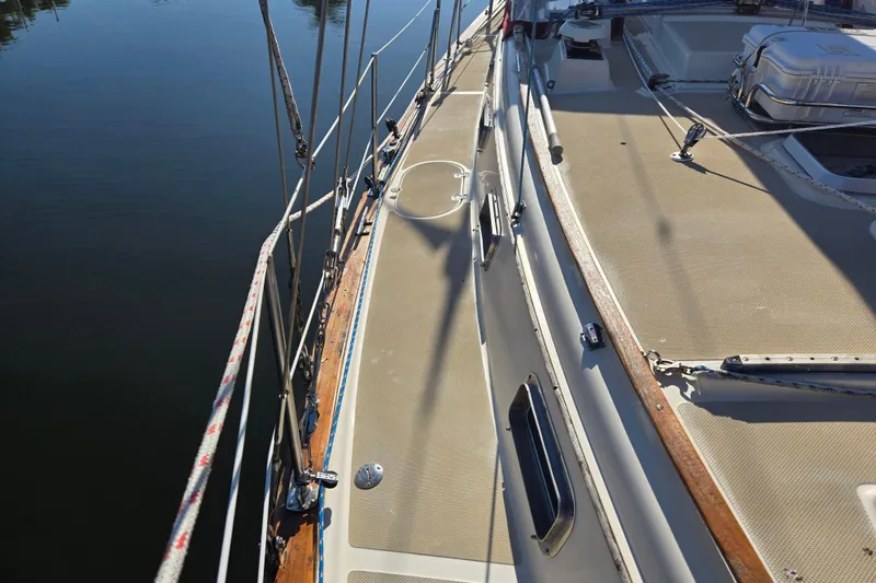 Slide: The Image of 1989 Island Packet 35 sailboat deck with rigging and calm water reflection. - 61