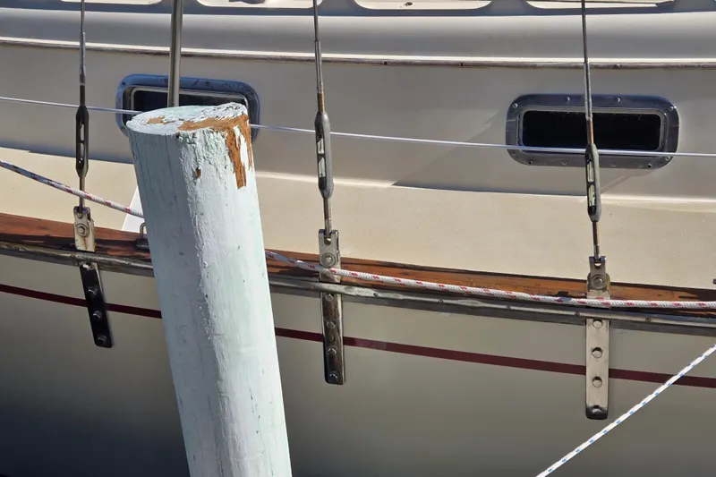 Slide: The Image of 1989 Island Packet 35 sailboat docked, showing hull and rigging details. - 64