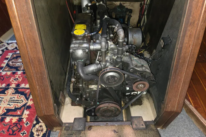 Slide: The Image of Engine compartment of a 1989 Island Packet 35 sailboat, featuring mechanical components. - 73