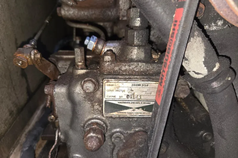 Slide: The Image of Engine of 1989 Island Packet 35 sailboat, featuring Yanmar diesel model 3HM35F. - 74