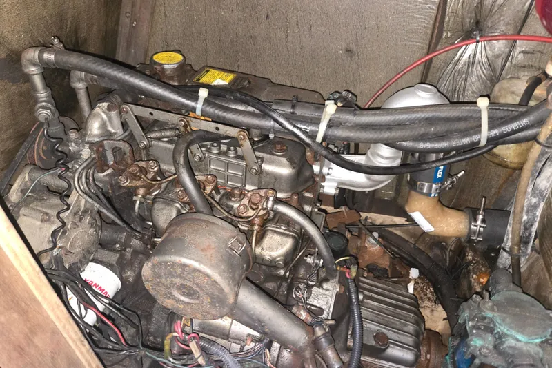 Slide: The Image of Engine compartment of a 1989 Island Packet 35 sailboat, showing detailed mechanical components. - 75