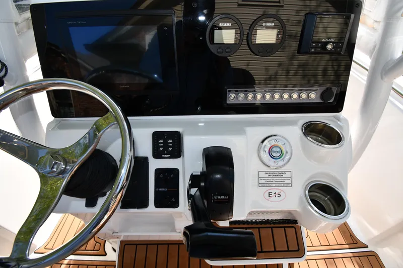Slide: The Image of Center console of 2021 Tidewater 210 CC Adventure boat with steering wheel and controls. - 12