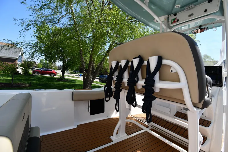 Slide: The Image of 2021 Tidewater 210 CC Adventure boat interior with rod holders and seating. - 16