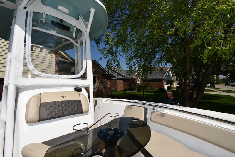 Slide: The Image of 2021 Tidewater 210 CC Adventure boat with seating, in a residential neighborhood setting. - 22