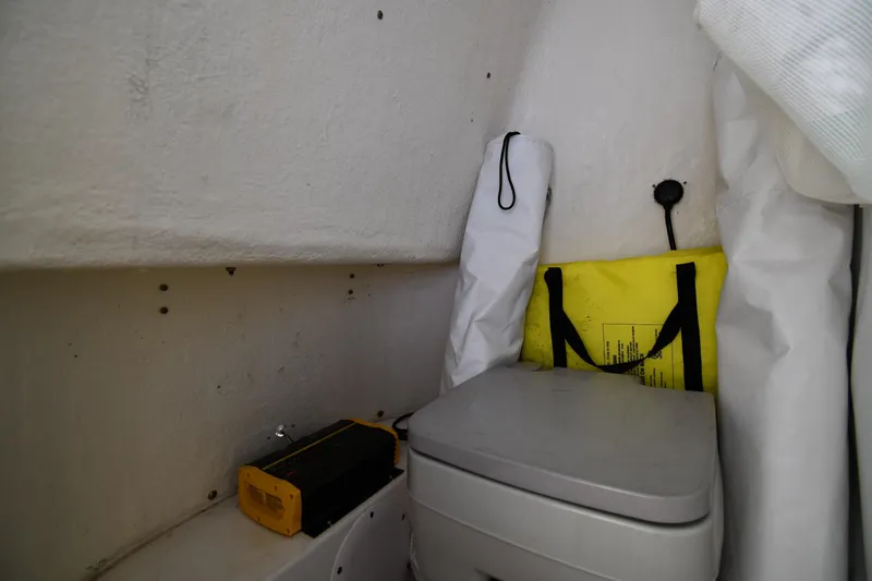 Slide: The Image of Interior of 2021 Tidewater 210 CC Adventure boat with storage and portable toilet. - 29