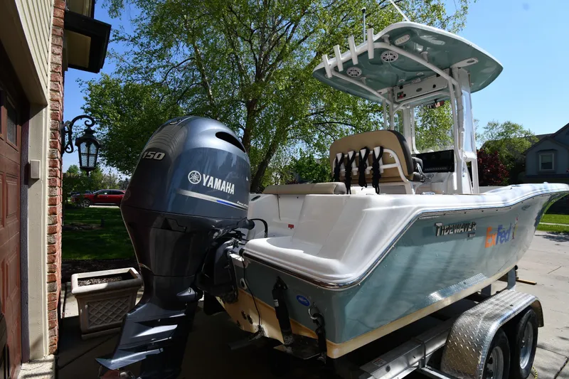 Slide: The Image of 2021 Tidewater 210 CC Adventure boat with Yamaha engine on a trailer, parked outdoors. - 6