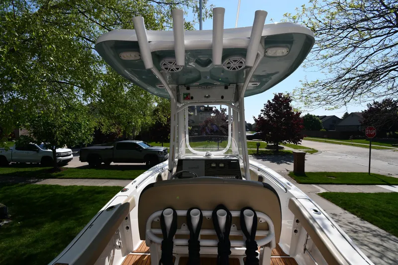Slide: The Image of 2021 Tidewater 210 CC Adventure boat parked in a suburban neighborhood. - 7