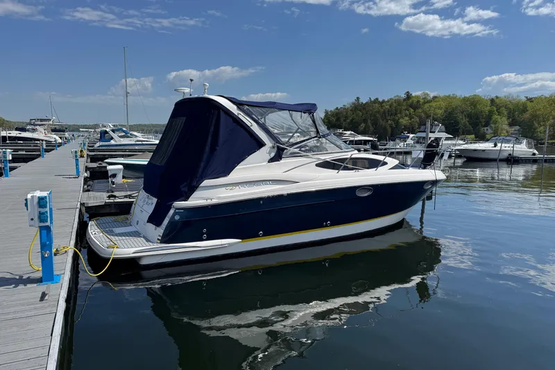 The Image of 2007 Regal 3060 Window Express boat docked at marina under blue sky. - 0