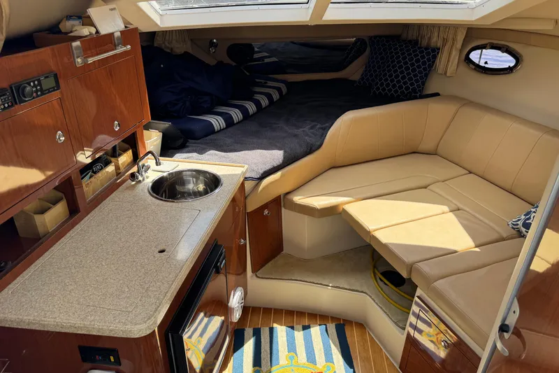 Slide: The Image of 2007 Regal 3060 Window Express cabin interior with kitchenette, seating, and sleeping area. - 11