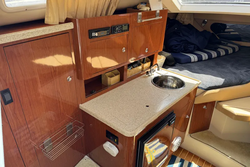 Slide: The Image of 2007 Regal 3060 Window Express cabin interior with kitchenette and cozy sleeping area. - 12