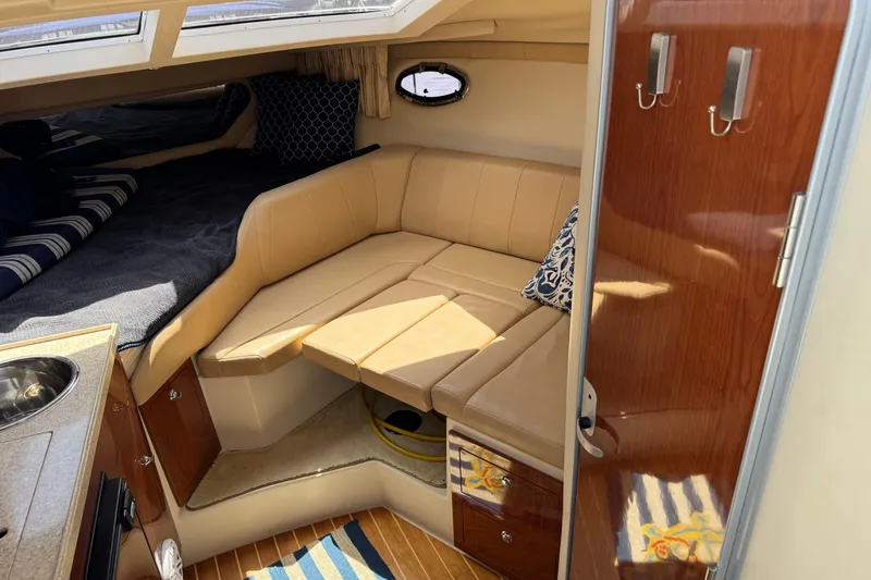 Slide: The Image of Interior of 2007 Regal 3060 Window Express boat with cozy seating and stylish decor. - 13