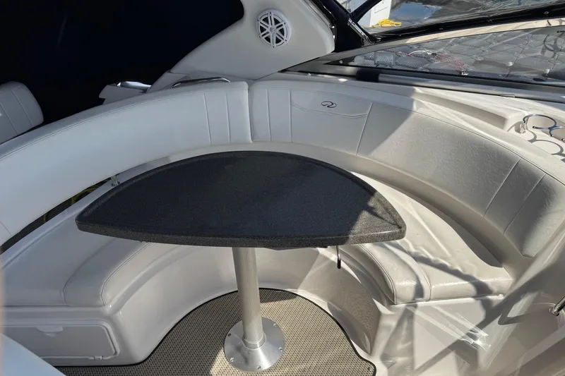 Slide: The Image of 2007 Regal 3060 Window Express boat interior with curved seating and a central table. - 14