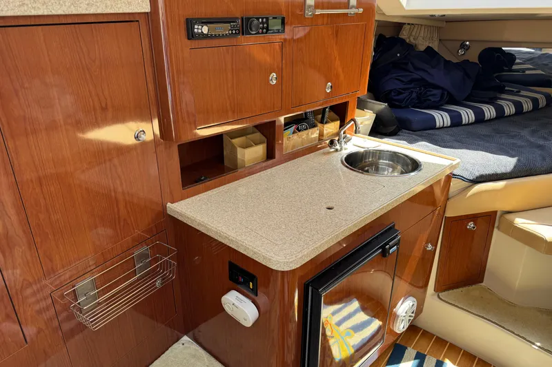 Slide: The Image of 2007 Regal 3060 Window Express cabin interior with kitchenette and cozy sleeping area. - 16