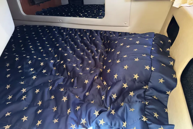 Slide: The Image of Cozy cabin interior of 2007 Regal 3060 Window Express with star-patterned bedding. - 19