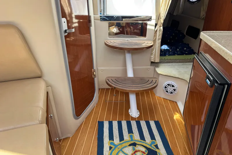 Slide: The Image of Interior of 2007 Regal 3060 Window Express boat with wooden steps and nautical decor. - 22