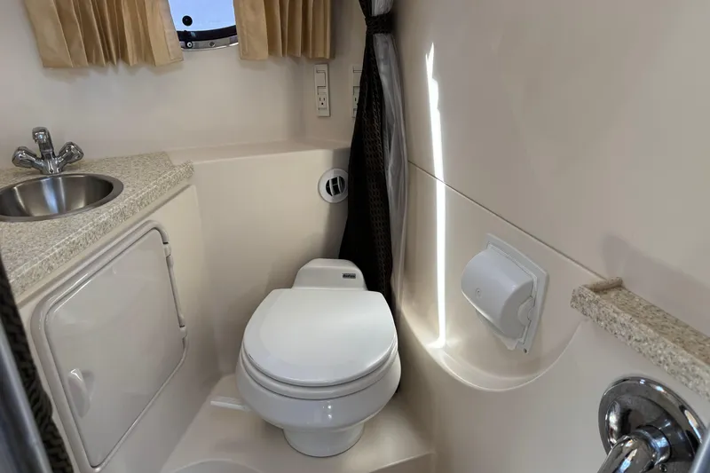 Slide: The Image of 2007 Regal 3060 Window Express boat bathroom with sink, toilet, and window. - 24