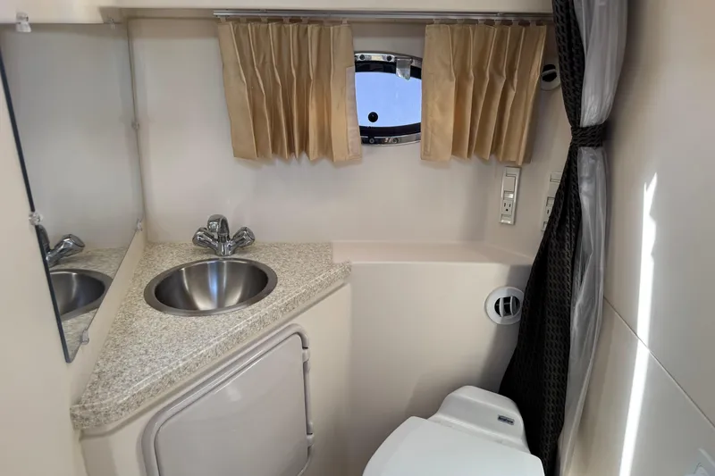 Slide: The Image of Compact bathroom in 2007 Regal 3060 Window Express boat with sink and toilet. - 25
