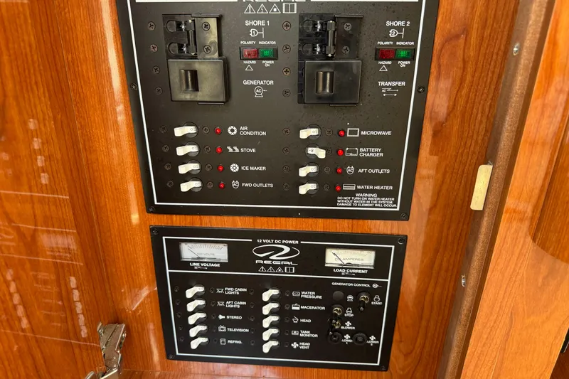Slide: The Image of Control panel of a 2007 Regal 3060 Window Express boat, featuring various switches and indicators. - 26