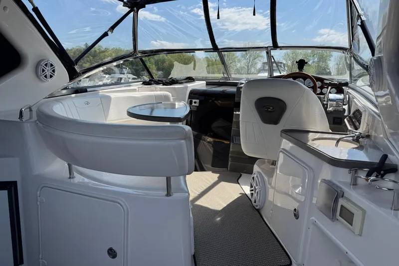 Slide: The Image of Interior of a 2007 Regal 3060 Window Express boat with seating and helm. - 3
