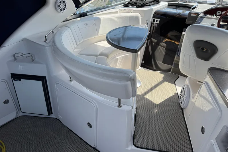 Slide: The Image of Interior of a 2007 Regal 3060 Window Express boat with white seating and table. - 4