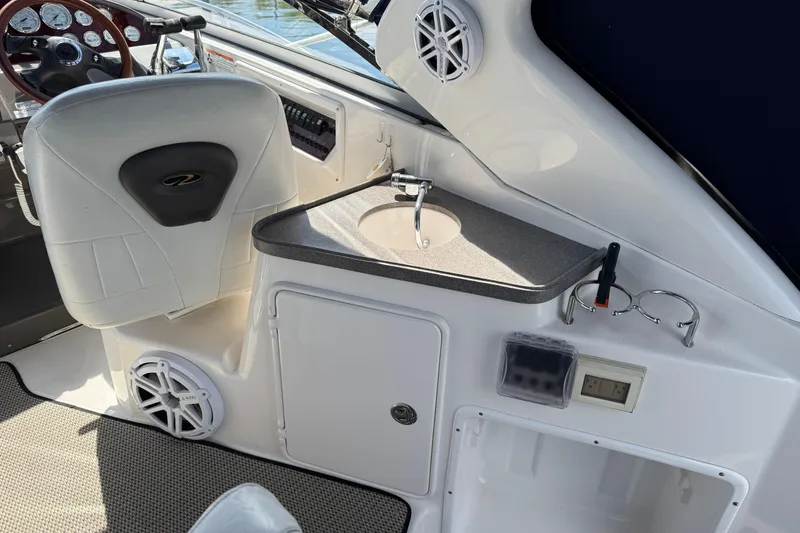 Slide: The Image of Interior of a 2007 Regal 3060 Window Express boat with helm and sink area. - 6