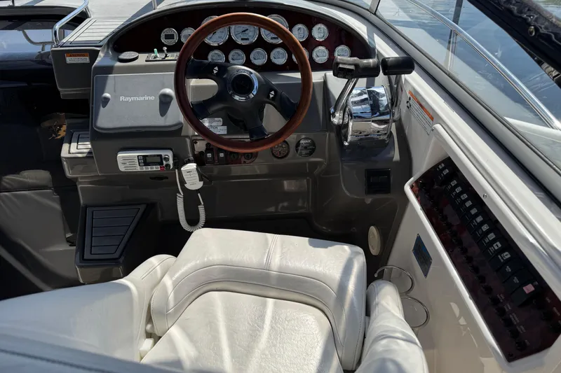 Slide: The Image of 2007 Regal 3060 Window Express boat cockpit with steering wheel and control panel. - 7