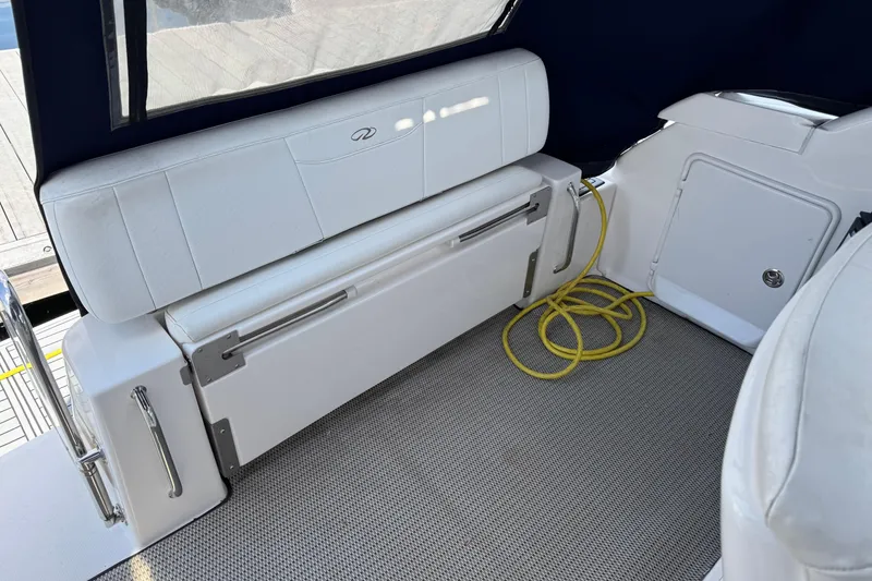 Slide: The Image of Interior of a 2007 Regal 3060 Window Express boat with white seating and yellow cord. - 8