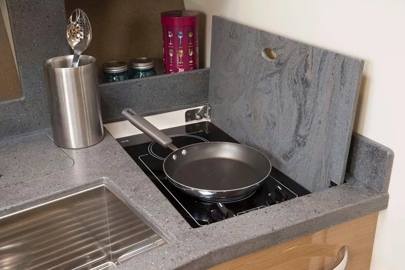 Slide: The Image of Manufacturer Provided Image: Compact kitchen area in 2016 Formula 37 Cruiser with stove, sink, and utensils. - 14